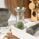 Stainless steel funnel for refilling mills, shakers and spice jars in retail packaging, rear view.