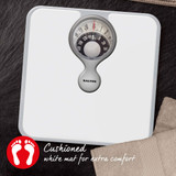 Mechanical bathroom scale with cushioned white mat, overhead view