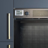 Digital kitchen timer attached to oven, shown in modern dark cabinetry.