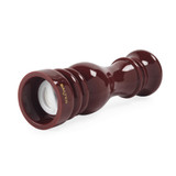 Red glossy wooden pepper mill showing ceramic grinder, angled side view
