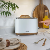 White 2-slice toaster with wood accents, shown from front on plain background.