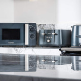 Salter grey microwave, two-slot toaster and kettle on kitchen counter