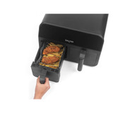 Black Salter air fryer with open drawer showing cooked breaded chicken and chips