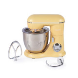 Yellow stand mixer with large metal mixing bowl and two attachments displayed