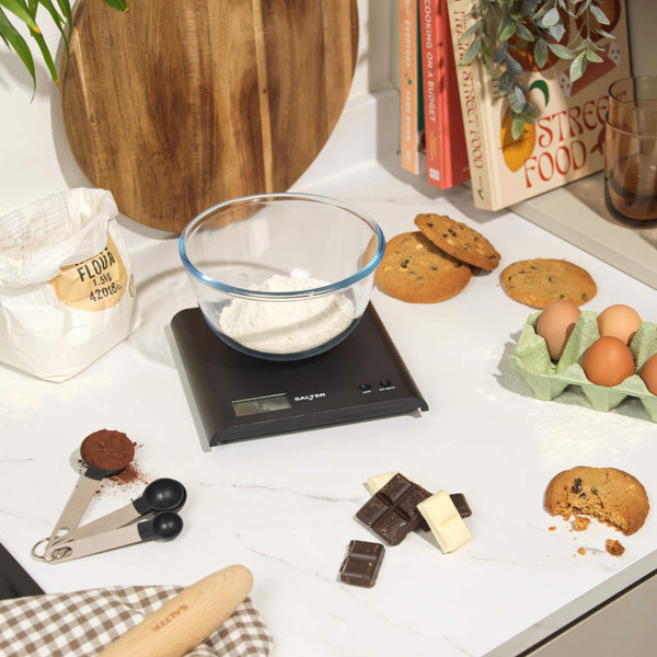 Black desktop device with buttons and display, shown from side angle