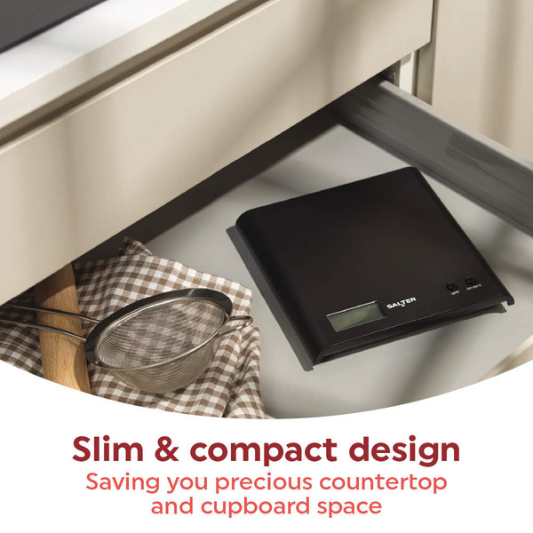 Black digital kitchen scale with slim, compact design, shown inside a drawer.