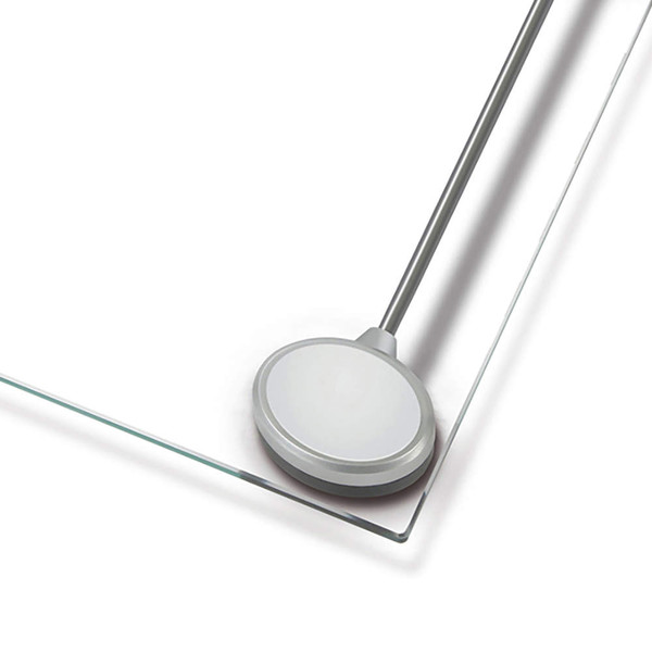 Glass bathroom scale with round silver sensor on corner