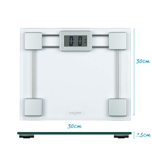 Silver digital bathroom scale with glass platform on tiled floor