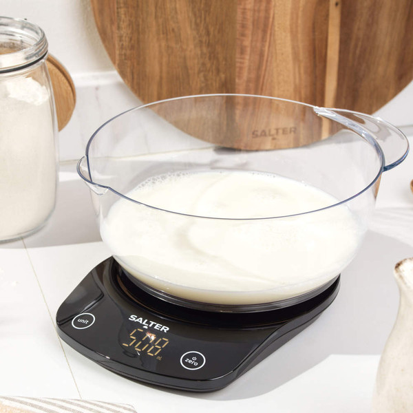 Black digital kitchen scale with round platform and LED display, showing 0 grams