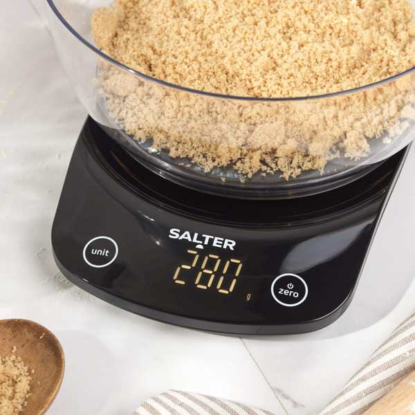 Digital kitchen scale with bowl of brown sugar, display showing 200 grams