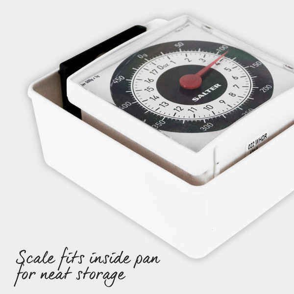 White mechanical kitchen scale stored neatly inside removable pan