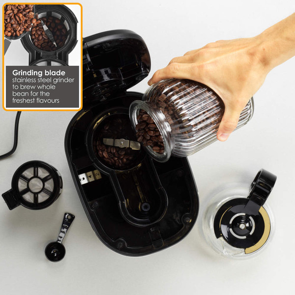 Person pouring coffee beans into grinder of black coffee machine, top view
