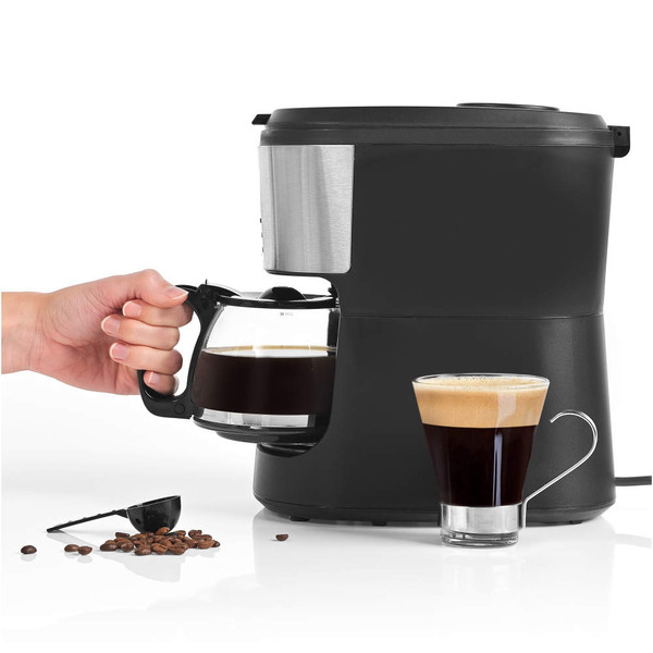 Salter coffee maker in black and silver, lid open, adding beans, glass mug of layered coffee beside.