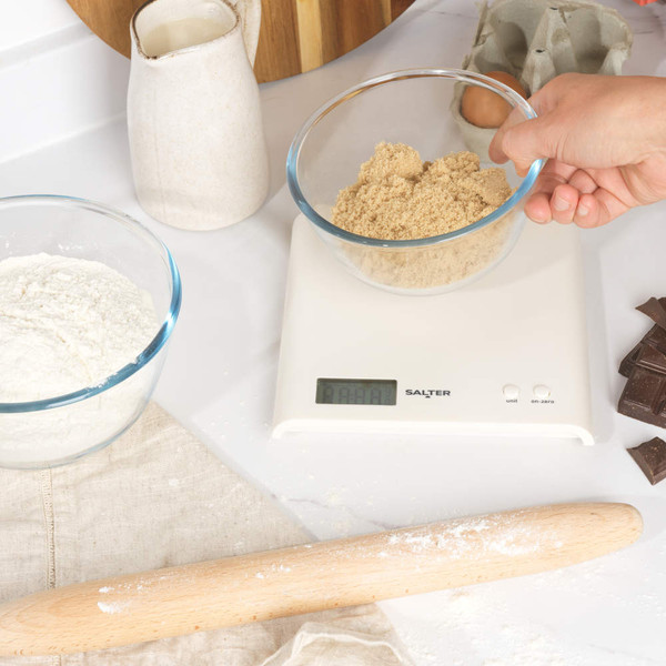 White digital kitchen scale with LCD display and two buttons, front view.