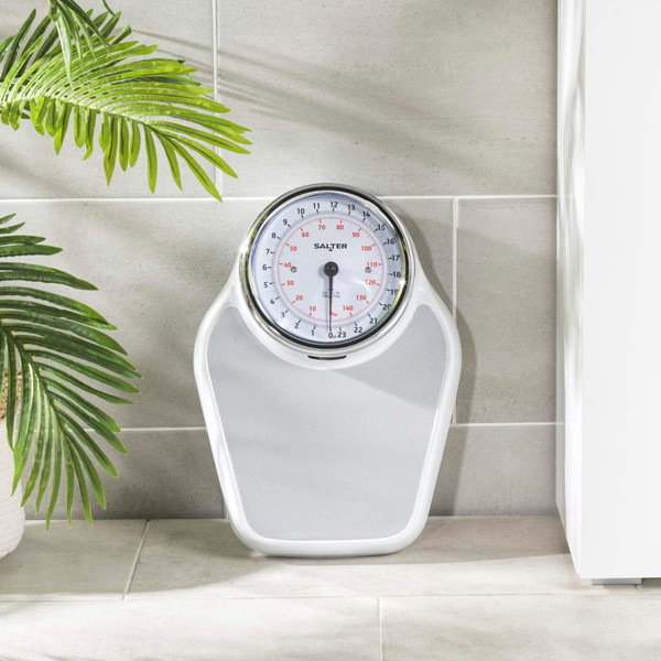 White mechanical bathroom scale with large easy-read dial, shown on tiled floor