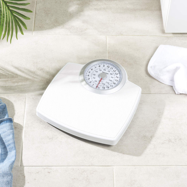 White mechanical bathroom scale with large dial, top-down view.
