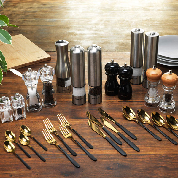 Assorted Salter salt and pepper grinders with gold cutlery on wooden table
