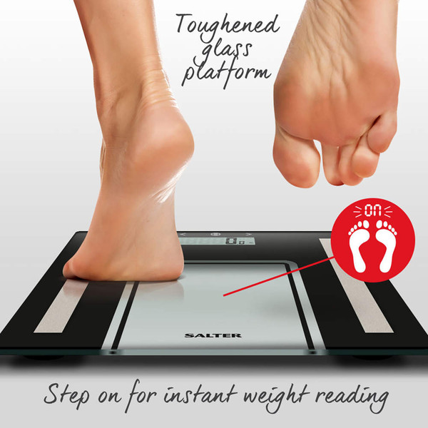 Digital glass bathroom scale with feet stepping on, highlighting instant weight reading feature
