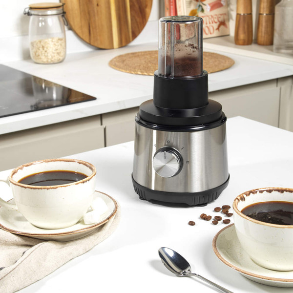 Silver blender with jug of mixed fruit, smoothie bottle and two glasses of juice.
