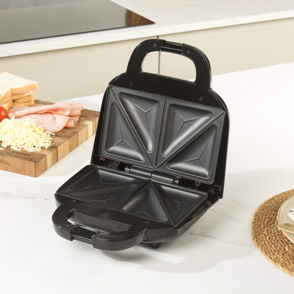 Black sandwich maker with copper detail and bow-shaped emblem, front view