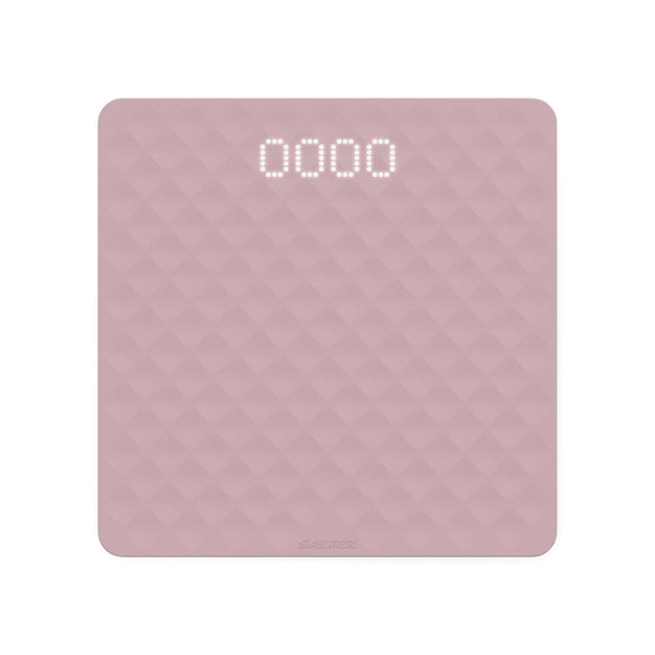 Pink square digital kitchen scale with textured surface, display showing 0 grams