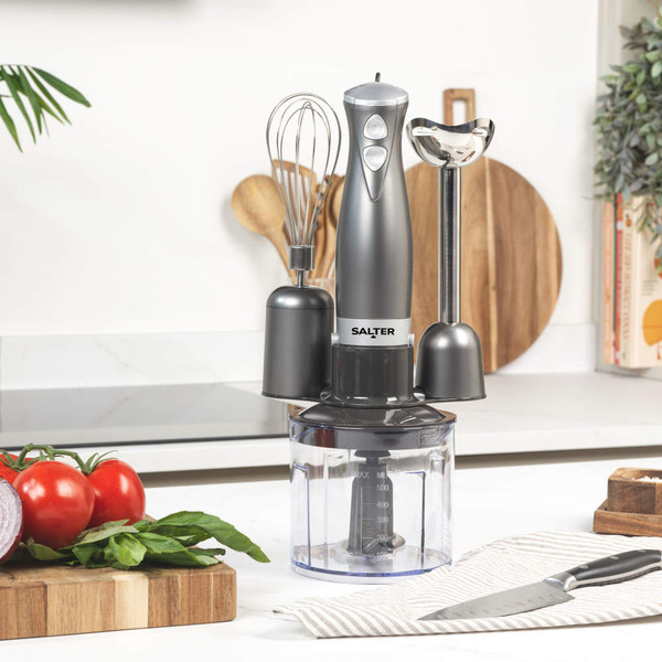 Gunmetal hand blender set with whisk, chopper and beaker attachments on kitchen counter