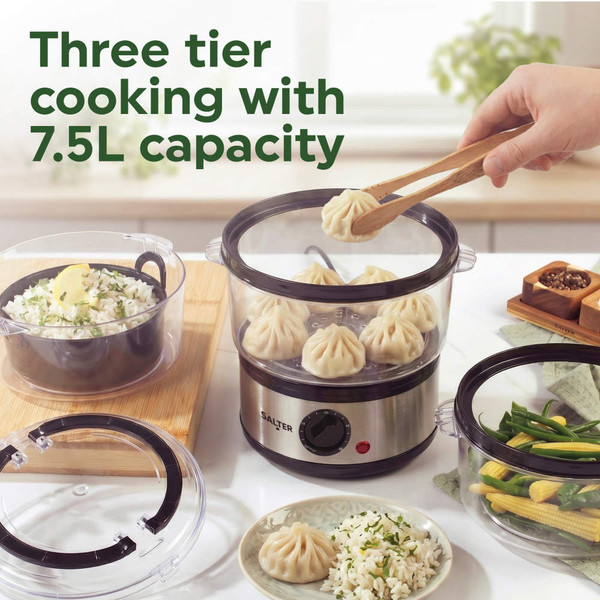 Three tier electric food steamer with rice, dumplings and vegetables shown in kitchen setting