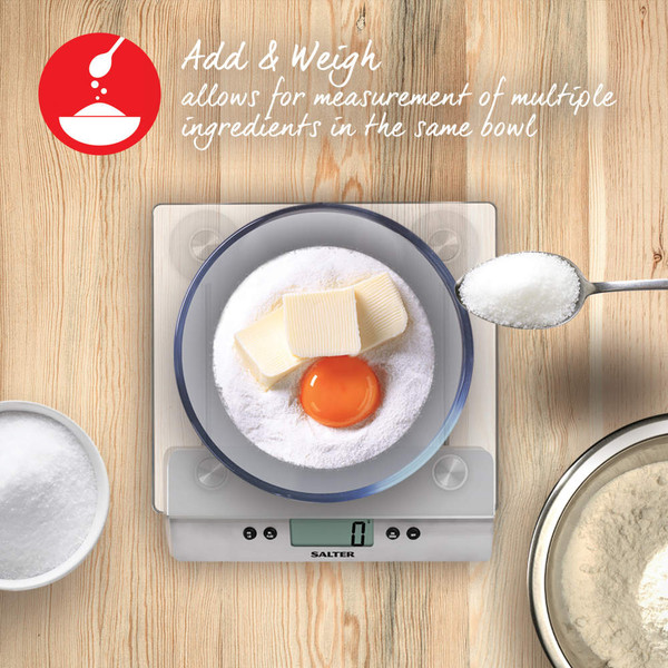 Kitchen scale with glass bowl measuring milk, showing 200 ml on display