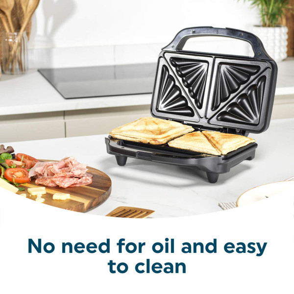 Black sandwich toaster open on kitchen counter