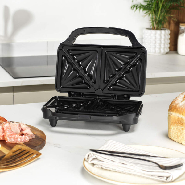 Black sandwich toaster open on kitchen counter