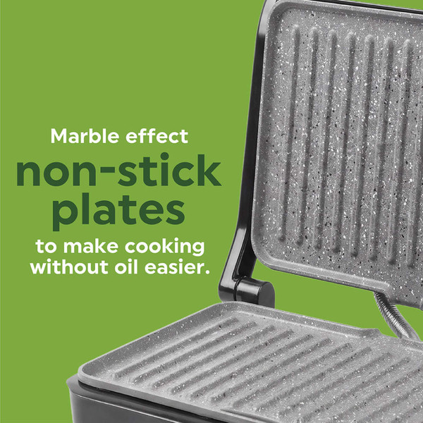 Black panini press toasting sandwich with tomato, cheese, and basil, lid partially closed