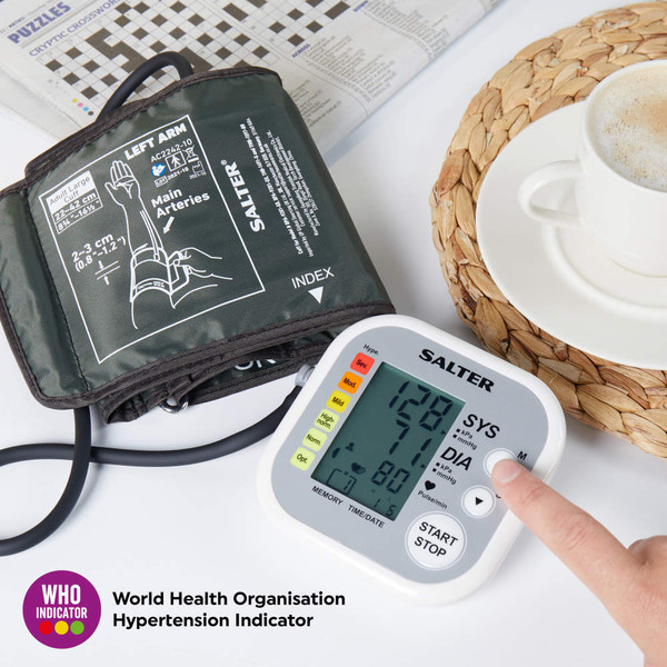 Salter upper arm blood pressure monitor with cuff, WHO indicator, cup of coffee and newspaper on table