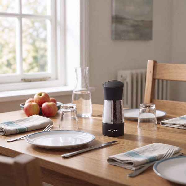 Black electric pepper mill on a dining table