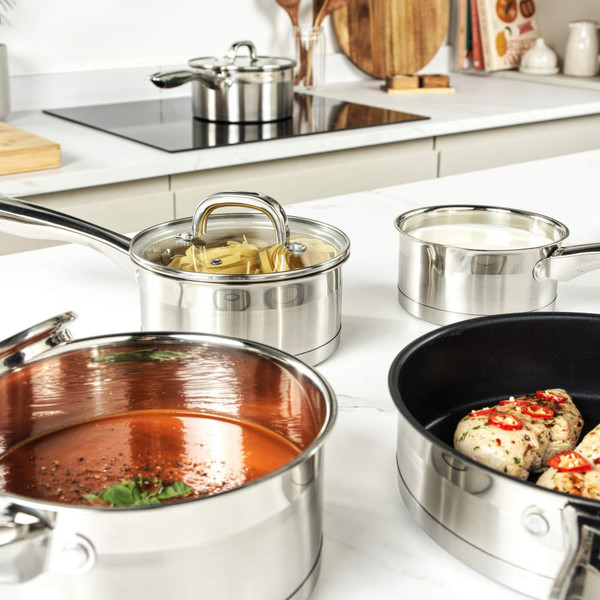 Set of three stainless steel saucepans with handles, nested side by side