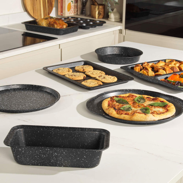 Speckled black non-stick bakeware set, various trays shown with baked foods