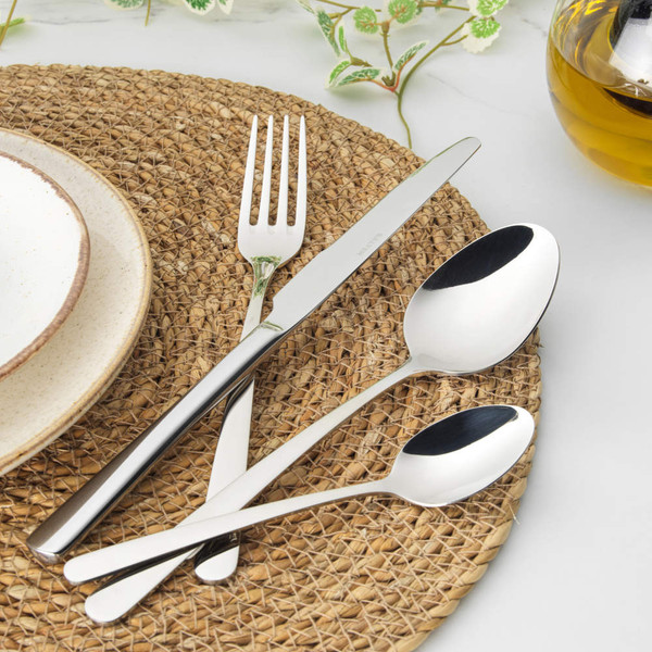 Four-piece silver cutlery set showing knife, fork, soup spoon and teaspoon.
