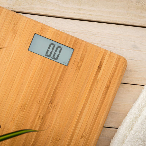Bamboo digital bathroom scale with clear display, shown on light wooden floor