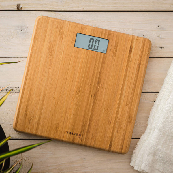 Bamboo digital bathroom scale with USB-C charging port, shown close up on wood surface