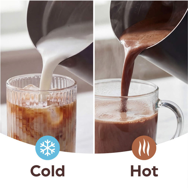 Glass of iced coffee with milk being poured in, on kitchen counter.