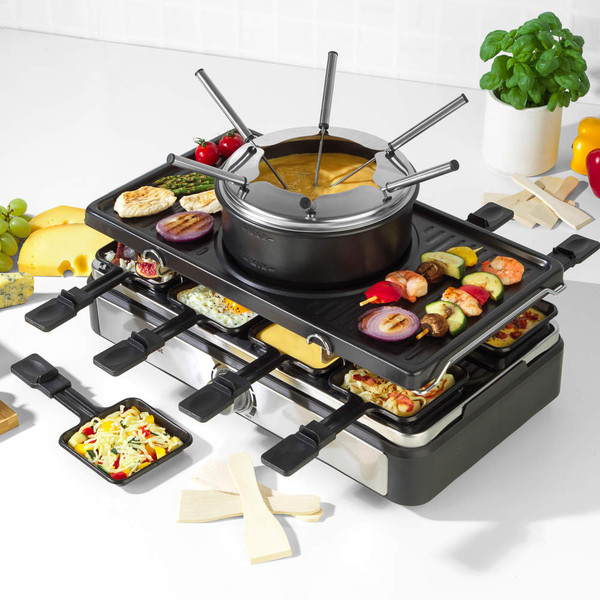 Cheese fondue set with forks, assorted breads, cheese, cured meats, grapes and olives