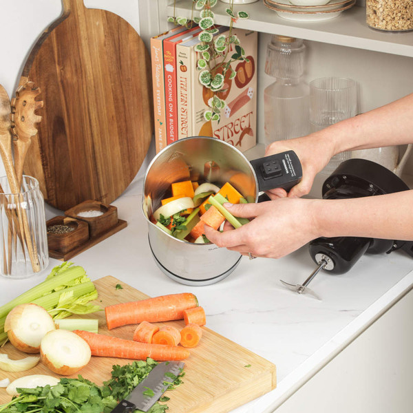 Vegetable prep with stainless steel food processor bowl on kitchen counter
