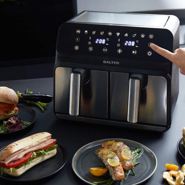 Salter dual air fryer with digital display in use, shown with plated food nearby
