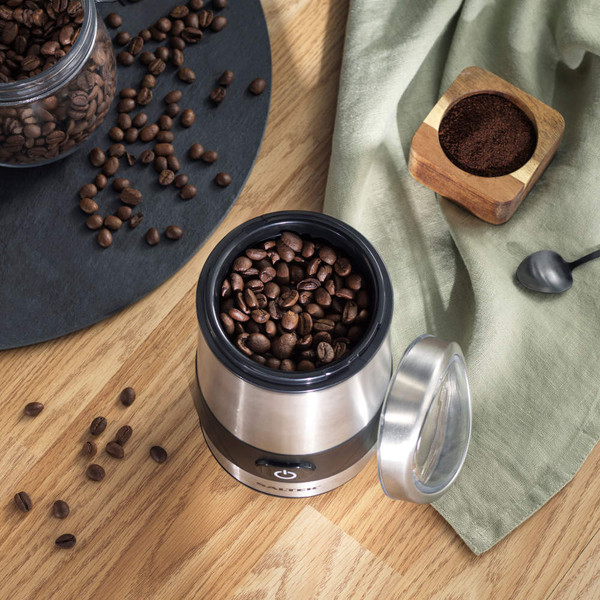 Salter stainless steel spice grinder in use on kitchen counter