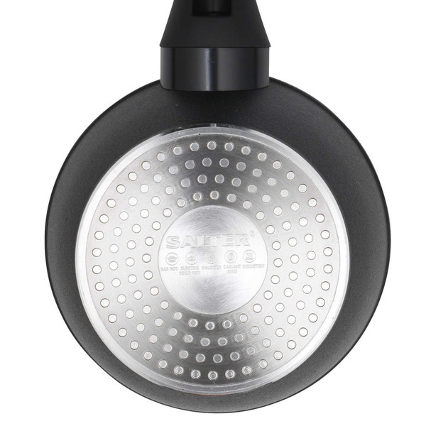 Black frying pan base with silver induction plate, close-up view