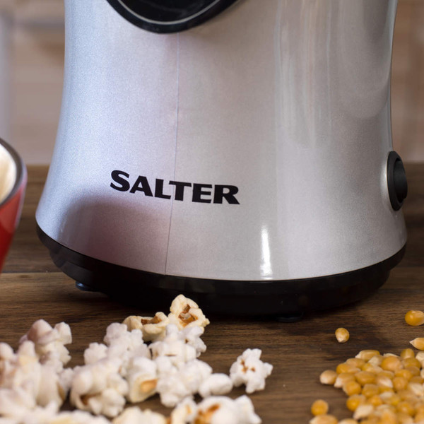 Salter silver popcorn maker base on wooden surface, popcorn and kernels visible