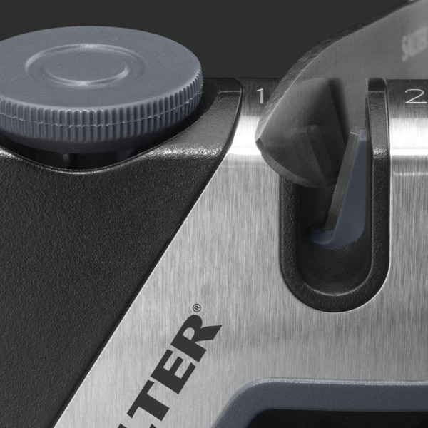 Manual knife sharpener close-up showing sharpening blade in slot