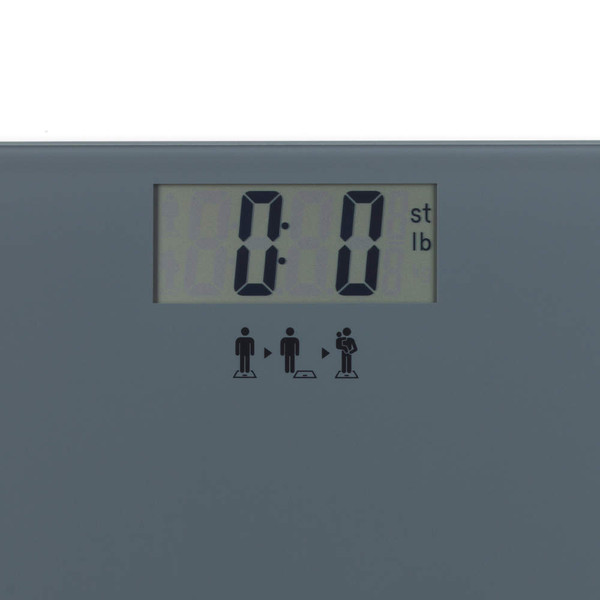 Close-up of digital bathroom scale display showing zero in stones and pounds.