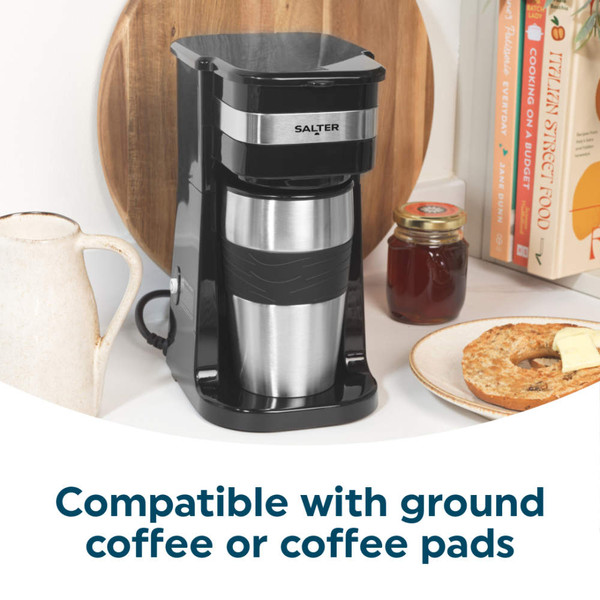 Single-serve black and silver coffee maker with stainless steel travel mug