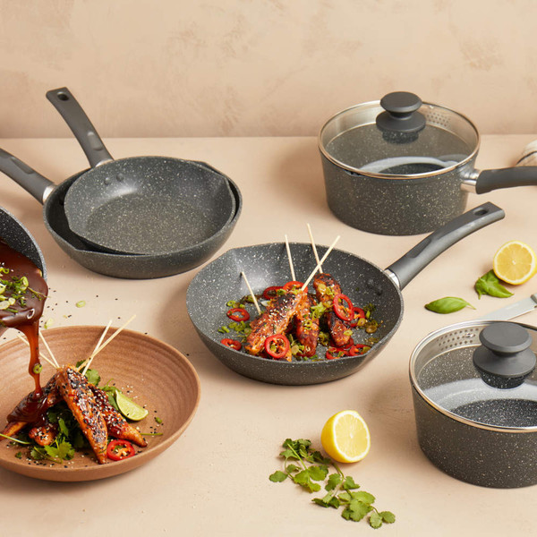 Set of grey non-stick saucepans and frying pans, lifestyle kitchen display