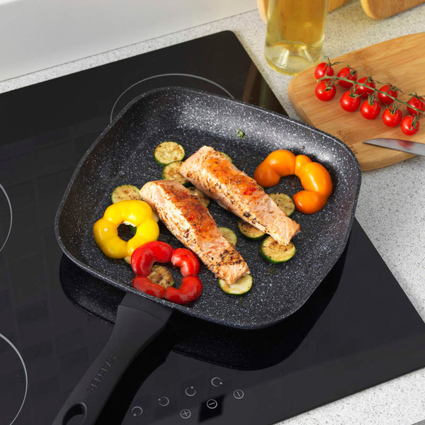 Set of black speckled non-stick frying pans and saucepans shown on kitchen worktop
